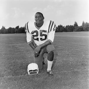 Primary view of object titled '[Football player number 25 posing in a football field]'.