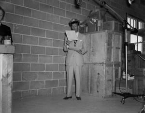 Primary view of object titled '[Frank Mills in a Humble oil hat reading a script]'.