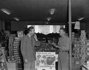 [Frank Mills and another man at a grocery store]