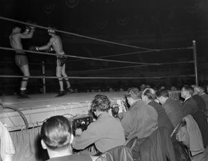 [Row of reporters at a boxing match]