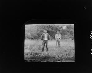 [Two men standing in a field]