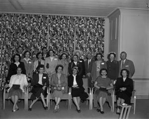[Group photograph of men and women in suits]
