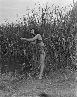 [Woman fishing while posing as Ghost River Kid]