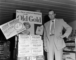 [Man posing with Old Gold cigarette display]