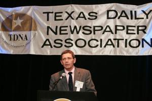 [Jay Smith speaking into microphone during TDNA conference]