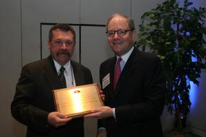 [Jeremy L. Halbreich handing out award during TDNA conference]