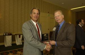Primary view of object titled '[Donnie Baggett handing out plaque award to Bill Cornwell]'.