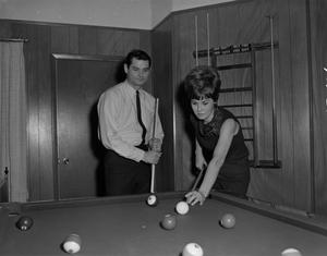 [Bill Enis playing pool with his wife]