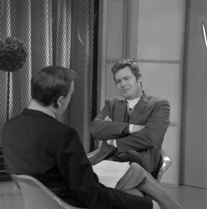 [Doug McClure seated for interview]