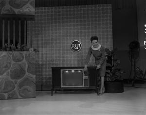 [Bobbie showing an RCA television]