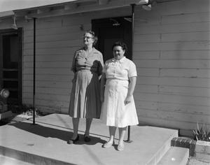 [Two women standing on a porch]