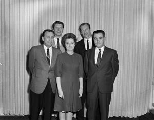 [Woman with four men in front of a curtain]