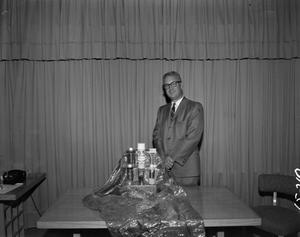[Man in suit with various products]