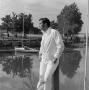 Photograph: [Man standing by the boat docks]