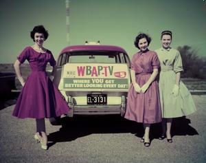 [Women with WBAP-TV sign]