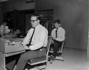 [Three man working in the newsroom]
