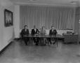 Photograph: [Four people at a table in an office]