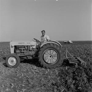 [Man on a Ford 4000 tractor]
