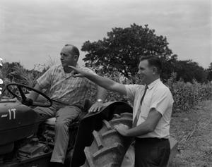 Primary view of object titled '[Bob Walsh and a man on a tractor]'.