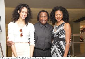 [Woman stands next to Curtis King and Kimberly Elise]