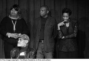 [Photograph of Isabell Cottrell, Melvin Van Peebles, and others on stage]
