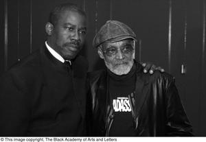 [Photograph of Melvin Van Peebles posing with a man]
