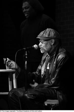 [Photograph of Melvin Van Peebles as he speaks on a stage at 24-Hour Film Feast]