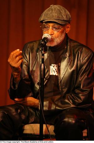 Primary view of object titled '[Photograph of director Melvin Van Peebles as he speaks on stage]'.