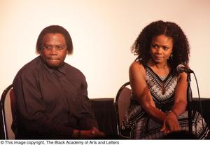 [Curtis King and Kimberly Elise look right while sitting]