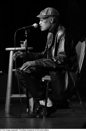 [Photograph of Melvin Van Peebles with a microphone]