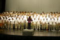 Primary view of [Choir members standing on stage together]