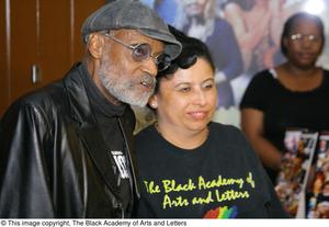[Photograph of Melvin Van Peebles with a woman wearing a TBAAL shirt, 2]