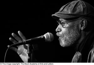 [Photograph of a closeup of director Melvin Van Peebles speaking into a microphone, 2]