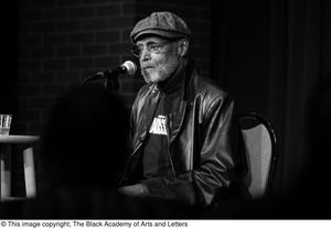 [Photograph of director Melvin Van Peebles speaking to an audience]