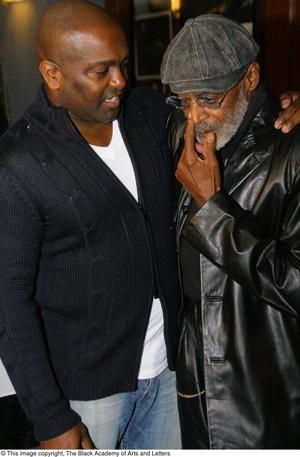 [Photograph of Melvin Van Peebles as he talks to a man at 24-Hour Film Feast]