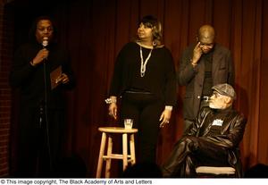 [Photograph of Curtis King, Melvin Van Peebles, and two unidentified individuals on stage]