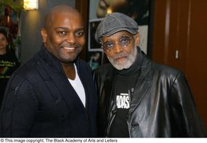 [Photograph of Melvin Van Peebles posing with an unidentified man]