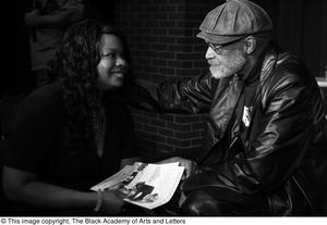 [Photograph of Melvin Van Peebles talking with a woman, 2]