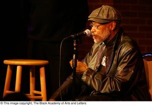 [Photograph of Melvin Van Peebles seated on stage at 24-Hour Film Feast]