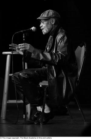 [Photograph of Melvin Van Peebles on stage at a film festival]