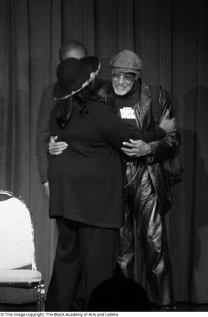 [Photograph of Melvin Van Peebles and Barbara Steele hugging on stage]