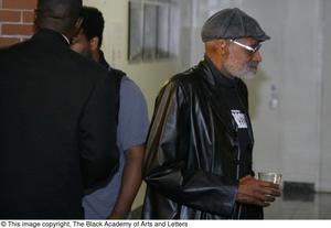 [Photograph of Melvin Van Peebles standing up with a drink]