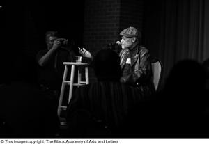 [Photograph of Melvin Van Peebles speaking to an audience]