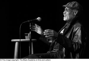 [Photograph of Melvin Van Peebles speaking at a film festival]
