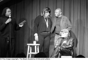 [Photograph of Curtis King and Melvin Van Peebles on stage with two other individuals]