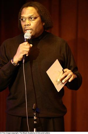 [Photograph of Curtis King standing up with a microphone]