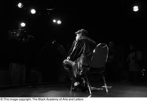 [Photograph of Melvin Van Peebles, taken from the back of the stage]