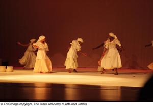 [Photograph of five women performing a dance on stage]