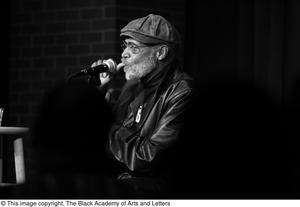 [Photograph of director Melvin Van Peebles talking to an audience]