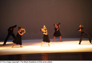[Photograph of five dancers performing a dance on stage in black clothes]